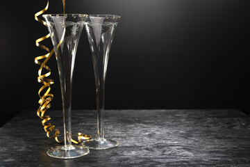 New Year concept, with bright light and champagne glass, abstract bokeh background