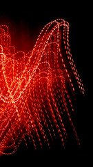 Fototapeta premium red dotted lines of lights on a black background