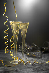 New Year concept, with bright light and champagne glass, abstract bokeh background