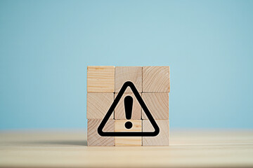 Warning sign on wooden blocks concept for risk management and safety awareness presentation slide design