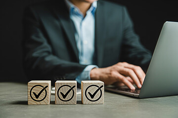 Task management checklist to do list wooden blocks and laptop for business productivity and efficiency