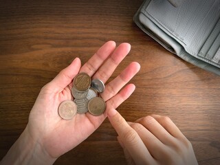 Counting Japanese Coins in Hand – Personal Finance and Saving Concept