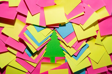 Colorful sticky notes revealing a Christmas tree, concept for holiday anticipation, waiting for Christmas amid daily routines, work-life balance, multitasking, seasonal planning, festive motivation