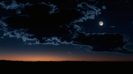 Moonlit sky full of stars above shadowy clouds, blue twilight meets golden horizon in calm night panorama.
