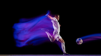 Soccer player kicking ball with dynamic blue and purple motion trail. Concept of sports performance, athletic movement analysis, and promotional visuals for tournaments and brands.