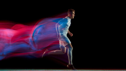 Soccer player running with long neon motion trail symbolizing stamina and persistence. Concept of athletic growth, focus, dedication used in fitness branding, sportswear ads, and training visuals.