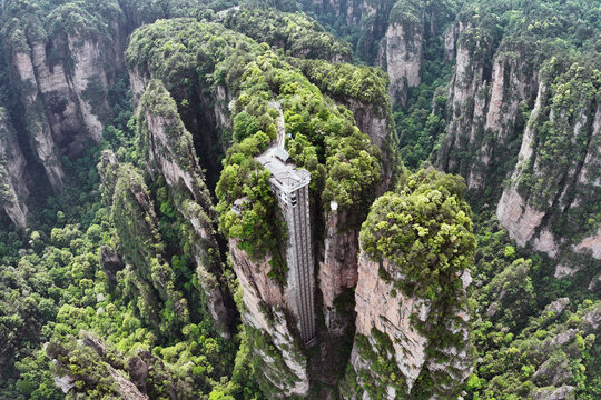 Aerial view of the Bailong Elevator rising dramatically through the towering sandstone pillars of Zhangjiajie National Forest Park, Hunan, China.