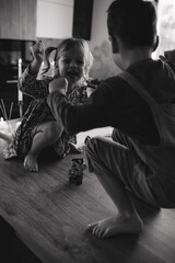 Brother and sister help their mother in the kitchen. The children are preparing for the holiday.