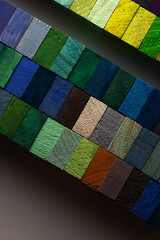 A low of lush, blue and green Spectrum of colored wooden blocks. Background or cover for something constructive, creative or diverse. Intentionally shot in low key.