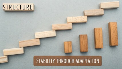 Wooden Blocks Representing Stability Through Adaptation in Business and Personal Growth with a Soft Gray Background