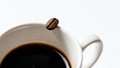 A single roasted coffee bean delicately balanced on the rim of a white ceramic cup filled with black coffee.