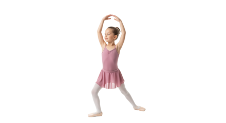 A young ballet dancer in a pink leotard and tights practices ballet, extending her arms above her head in a graceful pose.