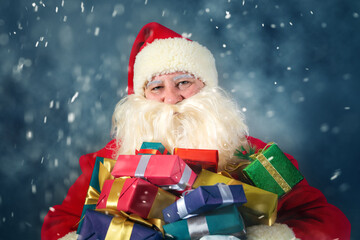 Portrait of Santa Claus holding gifts for children.  Christmas concept.