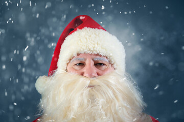 Close-up portrait of an authentic Santa Claus looking at the camera. Christmas concept.