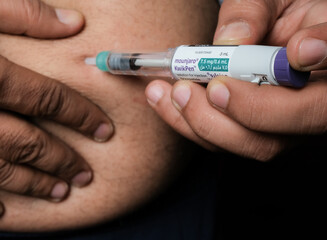 Basrah, Iraq - November 5, 2025: Subcutaneous Self-Injection of Tirzepatide (Mounjaro) Using a KwikPen Device