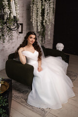 Portrait of a beautiful girl bride in a long wedding dress with an elegant hairstyle.