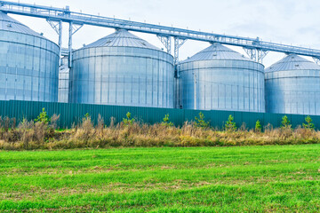 Agriculture grain silos storing harvest against cloudy sky