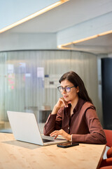 Young professional it specialist latin hispanic business lady typing on laptop pc at desk in...