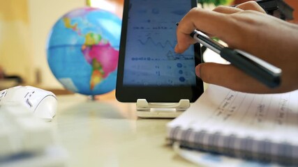 Office Desk with Glasses and Tablet Displaying Graphs - Powered by Adobe