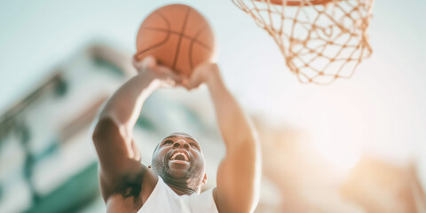 Athlete successfully shooting a basketball through the hoop, expressing excitement and energy on a sunny day