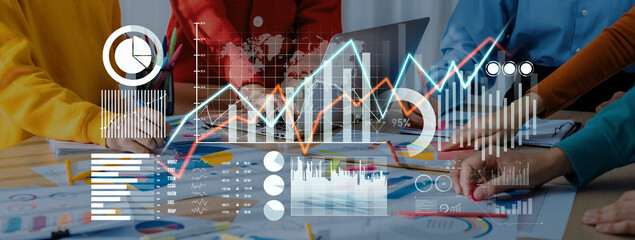 A diverse team works together analyzing financial data with charts and graphs in a modern office environment, highlighting collaboration and strategic planning. Scalp