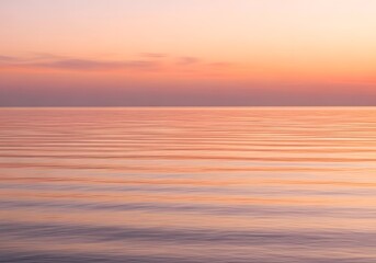 Pastel sunset over rippled sea horizon with soft gradient sky and horizontal bands