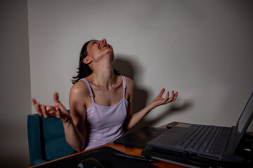 Young female digital artist looking proudly at her laptop