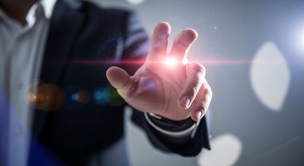 A hand reaching out with a bright light emanating from the palm in a dark suit setting scene