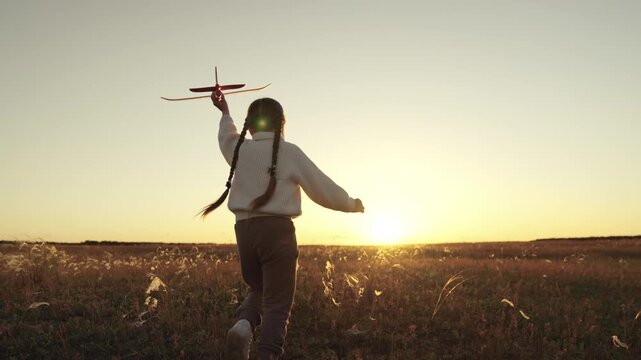 A dream plane pilot, Pad in hand, Flying dreams, Field of adventure, Kid at sunset, New day hope, Country freshness, Playing with imagination, Girl inspired, Warm glowing sky, Open arms to sky