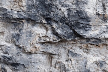 Fototapeta premium Rugged stone surface texture with shades of gray and black, featuring sharp edges, unevenness, and light spots for depth?ideal for creative design projects and backgrounds