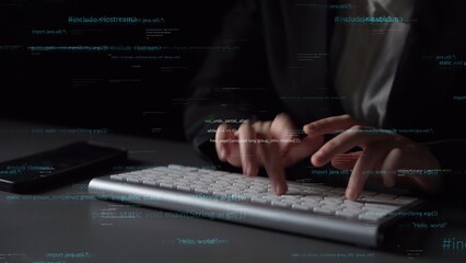 Close-up of hands typing on a sleek keyboard in a dark environment, with dynamic code and data...
