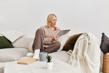 Blonde woman enjoying a cozy afternoon at home in her modern apartment