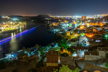 Night view of Aswan city lights along the Nile River, Egypt
