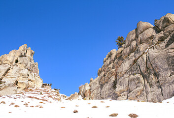 Ukrainian medieval cliff-side Tustan fortress ruins on snow in winter