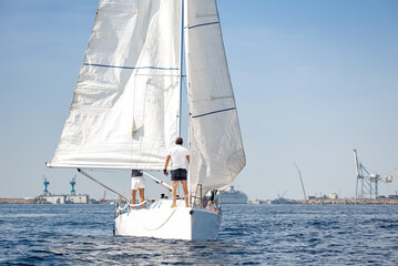 Naklejka premium Crew on sailboat in a calm sea