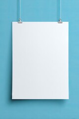 A white poster hanging from a blue wall