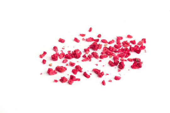 pieces of dried raspberries on a white background
