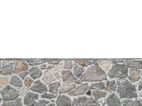 Gray stone wall made of irregular granite blocks is isolated.
