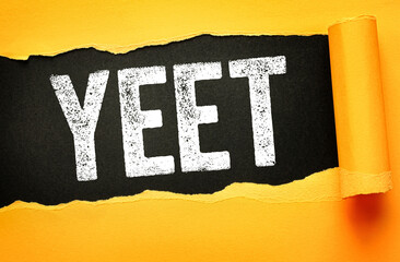 Yeet word shown on torn paper background. Modern slang expression for excitement, throwing...