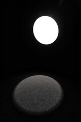 Enigmatic Shadow Play Abstract photography, dramatic chiaroscuro lighting casting sharp geometric shadows and soft organic shapes on a deeply textured, neutral toned fabric backdrop. High contrast,