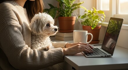 woman working on laptop at home with small dog on lap surrounded by plants and sunlight