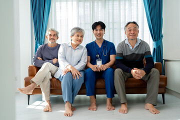 Fototapeta premium group of asian family senior man woman and son smiling sitting together in living room. home caregiver nurse visit retirement patient for health check up recovery process medical service