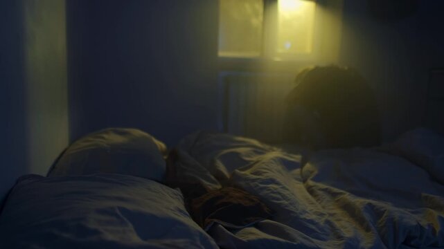 Man sitting alone on bed after relationship breakup, emotional pain and loneliness