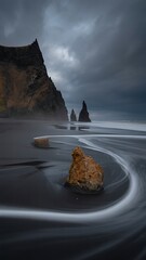 Dramatic Icelandic black sand beach landscape with crashing waves and imposing sea stacks
