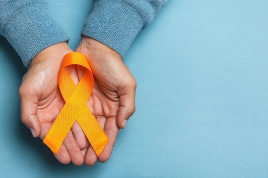 MS Awareness. Man Holding Orange Ribbon, Top View on Light Blue Background. Health Concept - Powered by Adobe