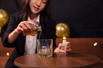 Closeup business woman holding a glass of whiskey