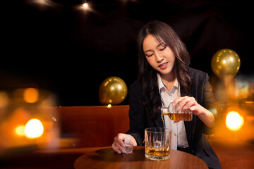 Closeup business woman holding a glass of whiskey