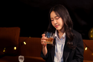Closeup business woman holding a glass of whiskey
