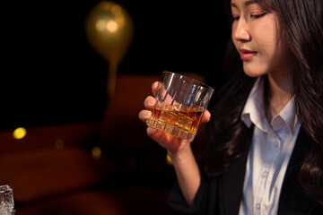 Closeup business woman holding a glass of whiskey