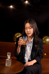 Closeup business woman holding a glass of whiskey
